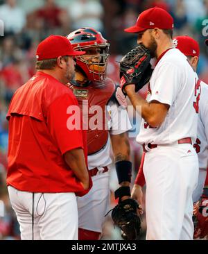 Rookie St. Louis Cardinals pitcher Michael Wacha walks from the bullpen to  the dugout with catcher Yadier Molina and pitching coach Derek Lilliquest,  before making his major league debut against the Kansas