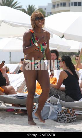 Serena Williams shows off her form in a cutaway bathing suit on the beach. Miami, FL. 3/25/10.     . Stock Photo