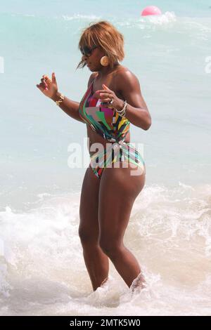 Serena Williams shows off her form in a cutaway bathing suit on the beach. Miami, FL. 3/25/10.     . Stock Photo