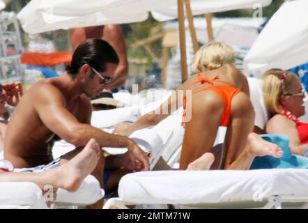 Exclusive!! Lorenzo Lamas' ex-wife Shauna Sand shows off her curves in the Miami heat today.  Reports are the Playboy Playmate and model has left LA to spend the summer in Miami and has reportedly angered Lamas in the process (the couple have three daughters together).  She spent the afternoon topping up her tan with Hawaiian Tropic oil in the company of a buff looking male friend before taking a stroll along the surf together.  Miami. FL, 4/23/08. Stock Photo