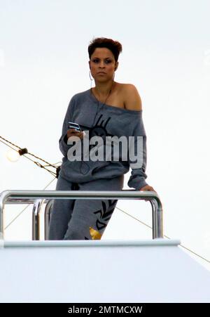 EXCLUSIVE!! Shaquille O'Neal's ex-wife Shaunie O'Neal films scenes for her VH1 reality series 'Basketball Wives' with other co-stars on a huge yacht in the Miami area. Shaunie wore a grey sweat suit during the shoot and before boarding the yacht, covered up with a white robe embroidered with her name. She also practiced firing a flare gun from the dock before heading out to the yacht. Once on board, she chatted on her cellphone. Miami, FL. 16th January 2012. Stock Photo