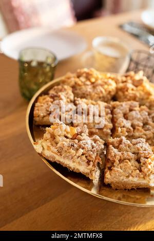 Apple Pie Pastry with a crumble crust in a rustical modern living room. Stock Photo