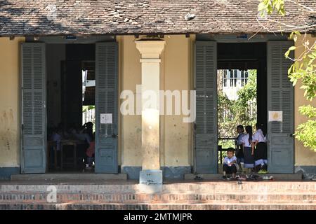 Students playing in the courtyard of a public school in Luang Prabang, Laos Stock Photo