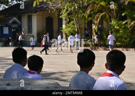 Students playing in the courtyard of a public school in Luang Prabang, Laos Stock Photo