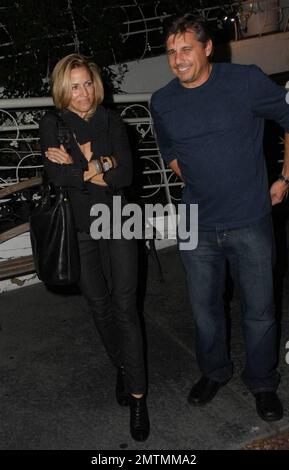 Sheryl Crowe looks a bit chilly as she stands waiting for her car outside the restaurant Madeos with a male friend. Los Angeles, CA. 10/6/09. Stock Photo