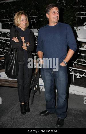 Sheryl Crowe looks a bit chilly as she stands waiting for her car outside the restaurant Madeos with a male friend. Los Angeles, CA. 10/6/09. Stock Photo