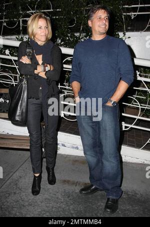 Sheryl Crowe looks a bit chilly as she stands waiting for her car outside the restaurant Madeos with a male friend. Los Angeles, CA. 10/6/09. Stock Photo