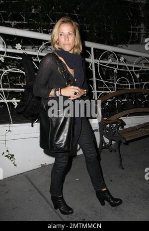 Sheryl Crowe looks a bit chilly as she stands waiting for her car outside the restaurant Madeos with a male friend. Los Angeles, CA. 10/6/09. Stock Photo