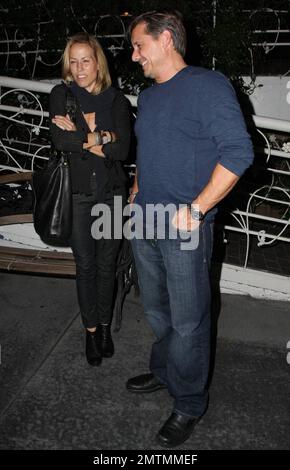 Sheryl Crowe looks a bit chilly as she stands waiting for her car outside the restaurant Madeos with a male friend. Los Angeles, CA. 10/6/09. Stock Photo