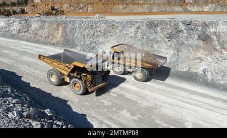 Huge dumper working at a limestone quarry. Stock Photo