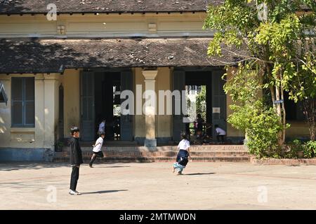 Students playing in the courtyard of a public school in Luang Prabang, Laos Stock Photo