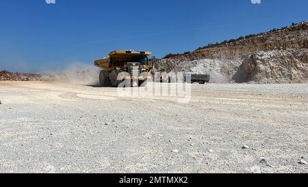 Huge dumper working at a limestone quarry. Stock Photo