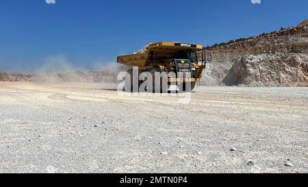 Huge dumper working at a limestone quarry. Stock Photo