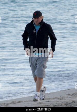 EXCLUSIVE!! Val Kilmer jogs off his Thanksgiving dinner with a sunset run on the beach. What a difference a few months makes! The actor who turns 52 on new years eve, was looking slimmer than when he was spotted on the set of his film 'Seven Below' in Cincinatti last August and at one point appeared to be loosing his shorts. Kilmer has several upcoming filming projects including 'The Hard Ride,' a western movie about a legendary gunfighter. Miami Beach, FL. 29th November 2011. Stock Photo