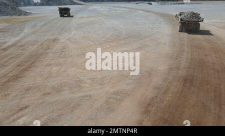 Huge dumpers working at a limestone quarry. Stock Photo