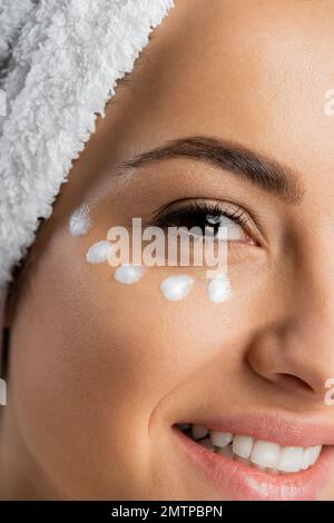 Cropped view of smiling young woman with cosmetic cream on face,stock image Stock Photo