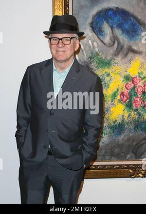 Actor, comedian and musician Steve Martin poses for photos while browsing exhibits at Art Basel Miami Beach with his wife Anne Stringfield. Miami Beach, FL. 12/2/10. Stock Photo