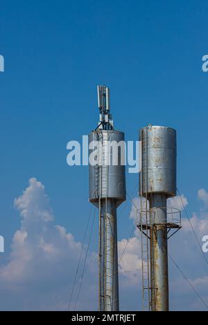 Two old rusty water towers in countryside field blue sky Stock Photo ...