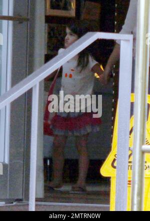 Suri Cruise leaves a luxury hotel accompanied by friends and adult chaperones. Suri is in town visiting while dad Tom Cruise films his new movie 'Rock of Ages' in Miami, FL. 7/1/11. Stock Photo