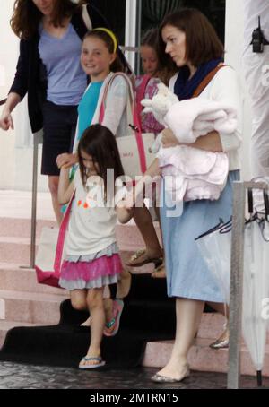 Suri Cruise leaves a luxury hotel accompanied by friends and adult chaperones. Suri is in town visiting while dad Tom Cruise films his new movie 'Rock of Ages' in Miami, FL. 7/1/11. Stock Photo