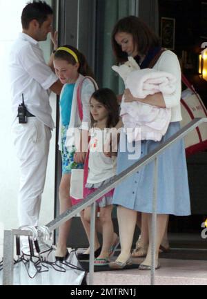 Suri Cruise leaves a luxury hotel accompanied by friends and adult chaperones. Suri is in town visiting while dad Tom Cruise films his new movie 'Rock of Ages' in Miami, FL. 7/1/11. Stock Photo