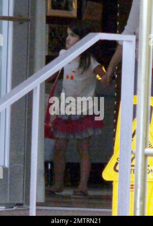 Suri Cruise leaves a luxury hotel accompanied by friends and adult chaperones. Suri is in town visiting while dad Tom Cruise films his new movie 'Rock of Ages' in Miami, FL. 7/1/11.   . Stock Photo