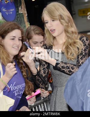 Country star Taylor Swift greeted her loving fans outside ABC's 'Good Morning America' in Times Square. Swift was recently announced as Billboard's Woman of the Year and at 21-years of age is the youngest to ever receive that honor. It's been a great week for Taylor as she also debut her new fragrance 'Wonderstruck' at Macy's Herald Square. New York, NY. 13th October 2011.   . Stock Photo