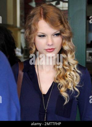 Pop country sensation Taylor Swift looks lovely as she leaves a Beverly Hills restaurant with friends after lunch.  Taylor, who can be seen in the May issue of Vogue magazine where she speaks of her love for sparkly dresses, keeps it casual this time in cute denim hot pants and flat gladiator sandals. Los Angeles, CA. 04/15/10. Stock Photo