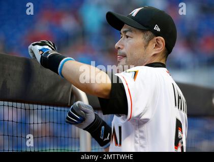 Combined photo shows Japanese outfielder Ichiro Suzuki of the Miami Marlins  wearing different T-shirts during the Major League Baseball club's spring  training in Jupiter, Florida, in 2015. The T-shirt on the bottom