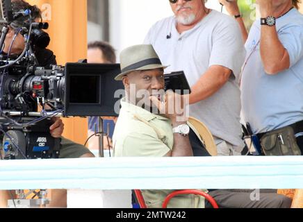 Michael Clarke Duncan film scenes on location for the TV series 'The Finder'.  While on set Michael Clarke Duncan, who got his make up touched up by a makeup artist, Geoff Stults and Saffron Burrows had a good laugh in between takes.  Saffron Burrows, who took direction and appeared to be playing the part of a waitress, looked great in aviator sunglasses, a tight brown top and flare jeans. Miami, FL. 02/24/11. Stock Photo