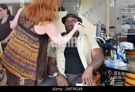 Michael Clarke Duncan film scenes on location for the TV series 'The Finder'.  While on set Michael Clarke Duncan, who got his make up touched up by a makeup artist, Geoff Stults and Saffron Burrows had a good laugh in between takes.  Saffron Burrows, who took direction and appeared to be playing the part of a waitress, looked great in aviator sunglasses, a tight brown top and flare jeans. Miami, FL. 02/24/11. Stock Photo