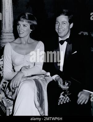 Film star Julie Andrews who won acclaim by American audiences attends her first Hollywood premiere with her husband, set designer Toni Walton, after the success of Mary Poppins. Stock Photo