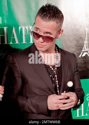 In a jacket that appeared a bit too tight around his middle Mike 'The Situation' Sorrentino of the MTV reality show 'Jersey Shore' wears rosary-bead necklaces and aviators as he poses for photographers with Marcy Depena as he hosts an evening at Chateau Nightclub & Gardens at Paris Las Vegas. Las Vegas, NV. 03/11/11. Stock Photo