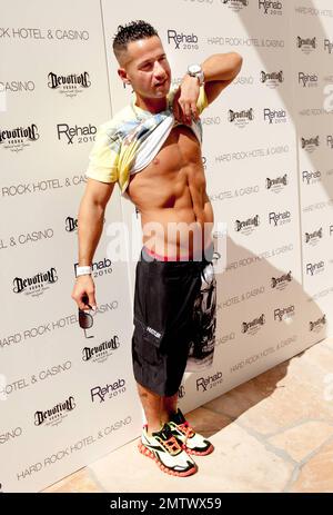 Staten Island's own Mike 'The Situation' Sorrentino of the MTV reality show 'Jersey Shore' flashes the camera his abs as he arrives at the Hard Rock Hotel and Casino REHAB club and pool to host a fourth of July weekend pool party.  Sorrentino pulled some wacky poses and carried a lollipop.  Las Vegas, NV. 07/04/10. Stock Photo