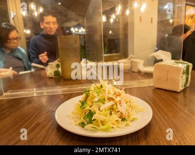 Taipei, DEC 19 2022 - Interior view of a restaurant with simple plastic sepration due to COVID-19 Stock Photo