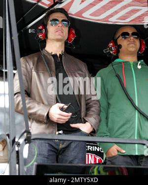 Actor Tom Cruise climbs into Jeff Gordon's pit box where he watches the Daytona 500 with son Connor after driving the pace car to start the race in Daytona Beach, FL. 2/15/09. Stock Photo