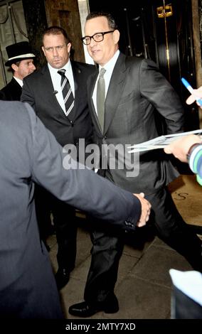 Actor Tom Hanks looks dapper in a black suit as he leaves his luxury hotel. Hanks did his best to keep a low profile as he left, turning away from autograph seekers and photographers. London, UK. 6/6/11. Stock Photo