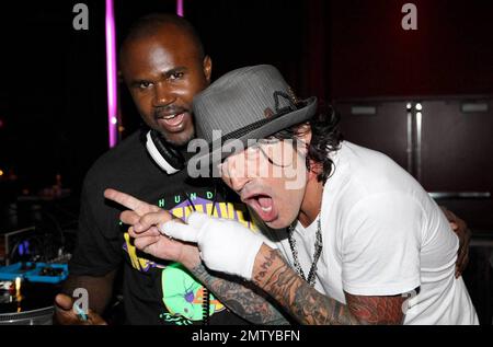 EXCLUSIVE!! Rocker Tommy Lee poses with DJ Kirk at Aura nightclub at Atlantis Paradise Island. Lee made several song requests and was very happy to find the songs he likes. Paradise Island, Bahamas. 8/26/09. Stock Photo