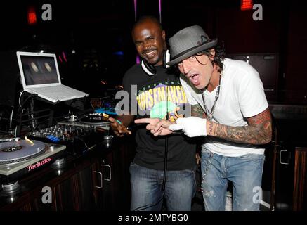 EXCLUSIVE!! Rocker Tommy Lee poses with DJ Kirk at Aura nightclub at Atlantis Paradise Island. Lee made several song requests and was very happy to find the songs he likes. Paradise Island, Bahamas. 8/26/09. Stock Photo