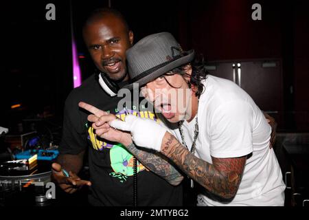 EXCLUSIVE!! Rocker Tommy Lee poses with DJ Kirk at Aura nightclub at Atlantis Paradise Island. Lee made several song requests and was very happy to find the songs he likes. Paradise Island, Bahamas. 8/26/09. Stock Photo