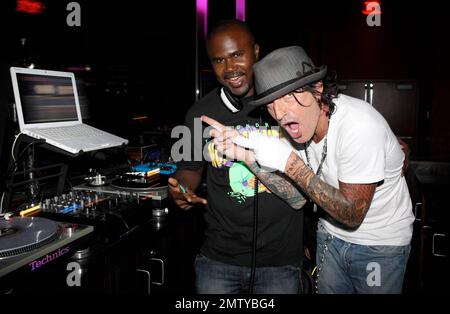 EXCLUSIVE!! Rocker Tommy Lee poses with DJ Kirk at Aura nightclub at Atlantis Paradise Island. Lee made several song requests and was very happy to find the songs he likes. Paradise Island, Bahamas. 8/26/09. Stock Photo