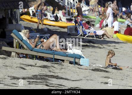 EXCLUSIVE!! Pregnant actress and author Tori Spelling wears a patterned swim suit as she relaxes on the beach with her dogs and son Liam during the Fourth of July holiday in Malibu, CA. 7/4/11. Stock Photo