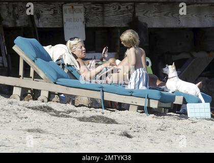 EXCLUSIVE!! Pregnant actress and author Tori Spelling wears a patterned swim suit as she relaxes on the beach with her dogs and son Liam during the Fourth of July holiday in Malibu, CA. 7/4/11. Stock Photo