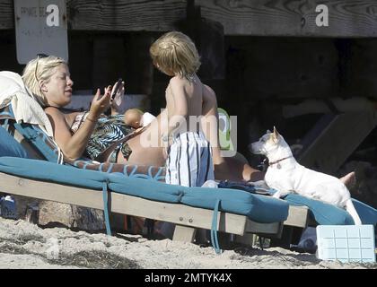 EXCLUSIVE!! Pregnant actress and author Tori Spelling wears a patterned swim suit as she relaxes on the beach with her dogs and son Liam during the Fourth of July holiday in Malibu, CA. 7/4/11.   . Stock Photo