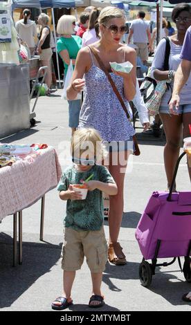 Tori Spelling and husband Dean McDermott spend the day at a Los Angeles farmer's market with their kids, son Liam and daughter Stella.  Tori showed off her infamous chest, ate some food and walked about with her kids who enjoyed frozen yogurt.  Dean walked with a cane as he is currently recovering from a dirt bike accident that reportedly saw him puncture a lung. Los Angeles, CA. 08/08/10. Stock Photo