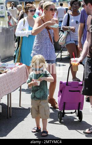 Tori Spelling and husband Dean McDermott spend the day at a Los Angeles farmer's market with their kids, son Liam and daughter Stella.  Tori showed off her infamous chest, ate some food and walked about with her kids who enjoyed frozen yogurt.  Dean walked with a cane as he is currently recovering from a dirt bike accident that reportedly saw him puncture a lung. Los Angeles, CA. 08/08/10. Stock Photo