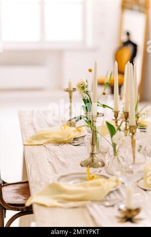 Beautiful Easter table setting with floral decor indoors Stock Photo