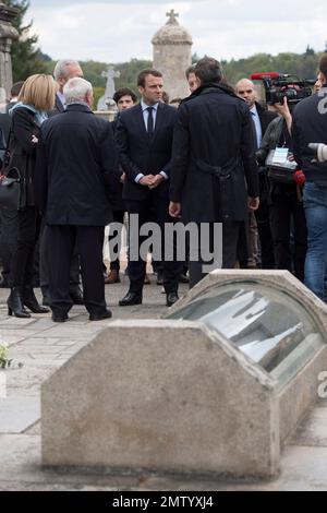 French independent centrist presidential candidate Emmanuel Macron, center, listens to unidentified officials while visiting the French martyr village of Oradour-sur-Glane, central France, Friday, April 28, 2017. France's troubled wartime past is taking center stage Friday in the country's highly charged presidential race, as centrist Emmanuel Macron visited the site of France's worst Nazi massacre and Marine Le Pen's far-right party suffered a new blow over alleged Holocaust denial. (AP Photo)