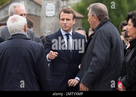 French independent centrist presidential candidate Emmanuel Macron, center, listens to unidentified officials while visiting the French martyr village of Oradour-sur-Glane, central France, Friday, April 28, 2017. France's troubled wartime past is taking center stage Friday in the country's highly charged presidential race, as centrist Emmanuel Macron visited the site of France's worst Nazi massacre and Marine Le Pen's far-right party suffered a new blow over alleged Holocaust denial. (AP Photo)