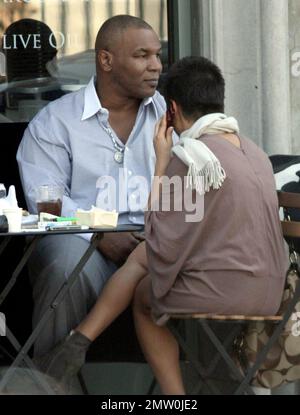 Mike Tyson lunches with two female friends at Joans On Third. Tyson is reportedly in talks for a potential third boxing rematch with Evander Holyfield. Tyson was disqualified during their last bout in 1997 when Tyson  took a bite out Holyfield's ear. Los Angeles, Ca. 3/5/08. Stock Photo